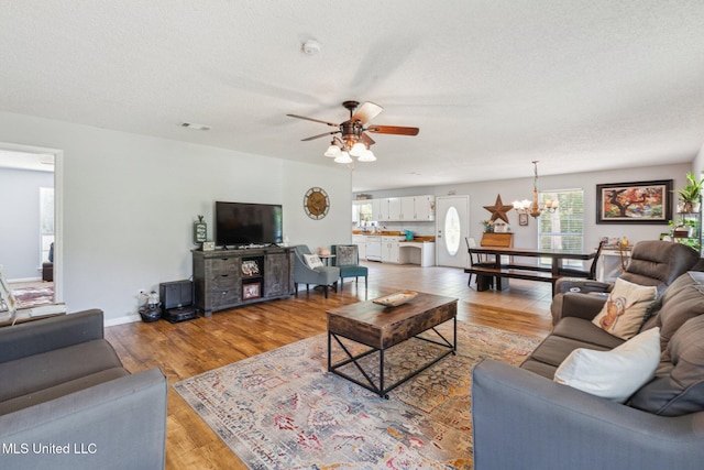 4628 Breland Rd, Vancleave, MS 39565 - living room featuring a chandelier, light wood-style floors, a ceiling fan, and a textured ceiling