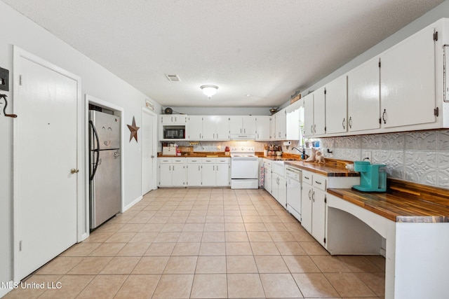 4628 Breland Rd, Vancleave, MS 39565 - kitchen with white appliances, a sink, light tile patterned flooring, and white cabinets