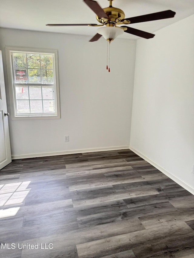 100 Warren St, Como, MS 38619 - empty room with dark wood-style floors, a ceiling fan, and baseboards