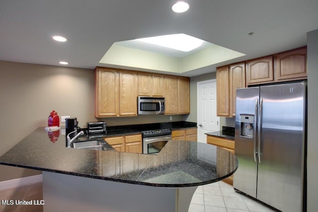 kitchen featuring kitchen peninsula, sink, light tile patterned floors, and stainless steel appliances