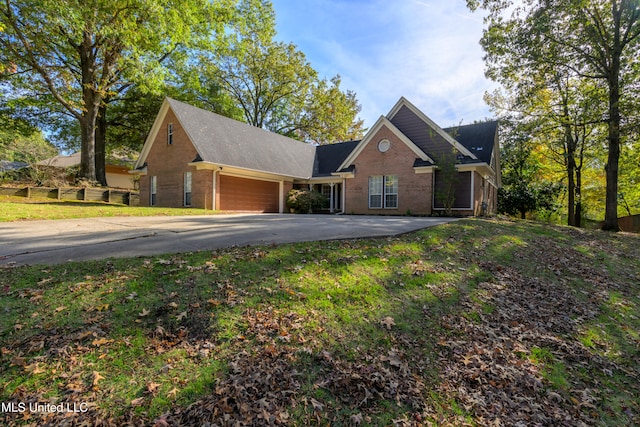 view of front of home featuring a garage and a front lawn