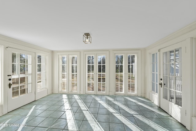 unfurnished sunroom featuring french doors