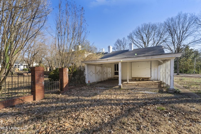 rear view of property with fence