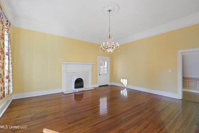 unfurnished living room with ornamental molding, a brick fireplace, and hardwood / wood-style floors