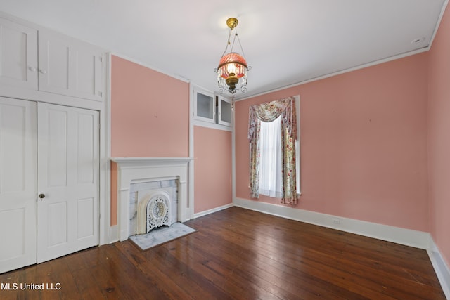 unfurnished living room with a fireplace with flush hearth, baseboards, and hardwood / wood-style floors