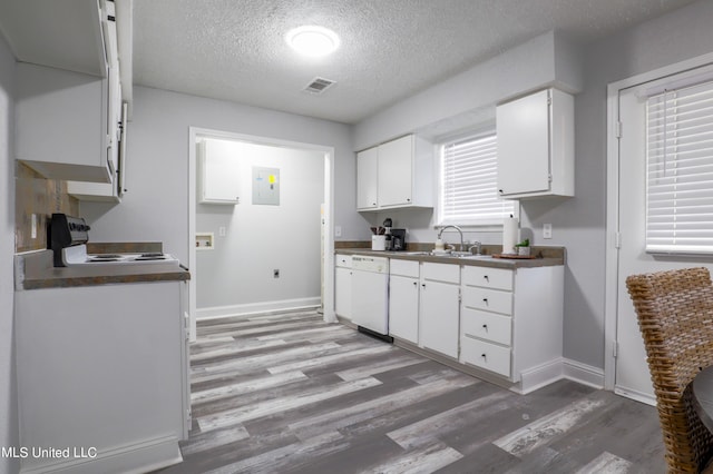 kitchen featuring white cabinets, dishwasher, stove, and a textured ceiling