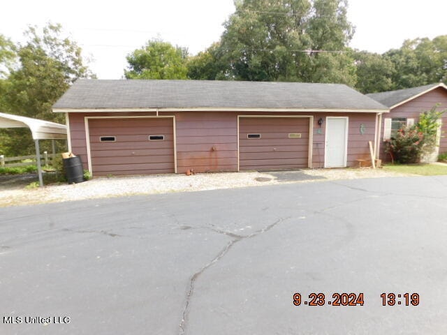 garage featuring a carport