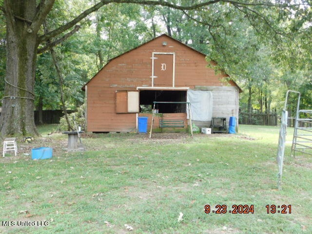 view of outbuilding with a yard