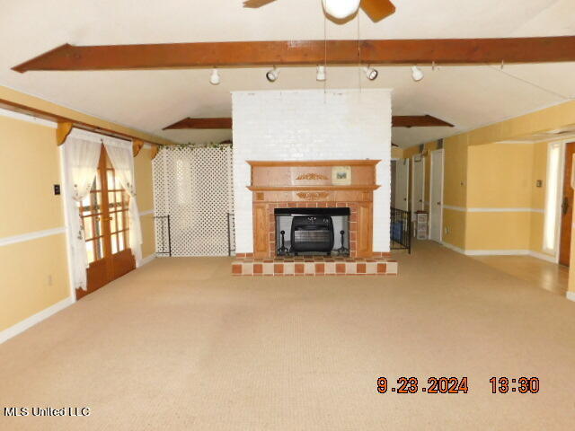 living room with beam ceiling and carpet flooring