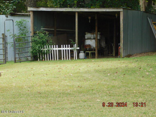 view of outdoor structure with a lawn