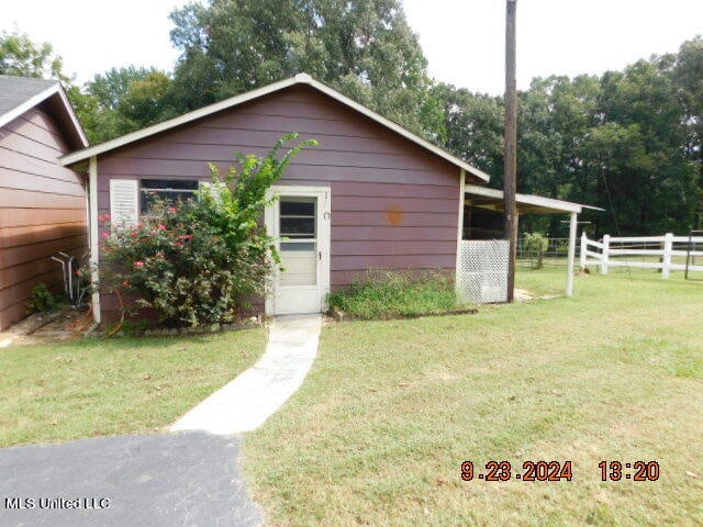 view of outdoor structure with a lawn