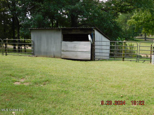 view of outbuilding with a yard