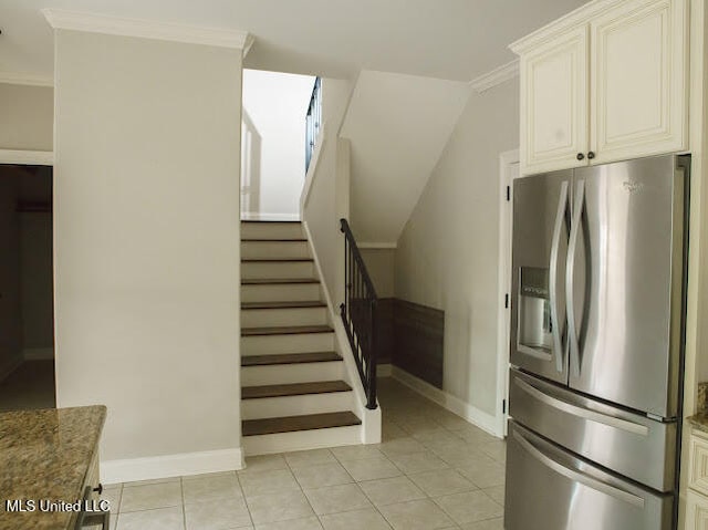 interior space with tile patterned flooring and crown molding