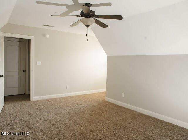 additional living space with light carpet, ceiling fan, and lofted ceiling