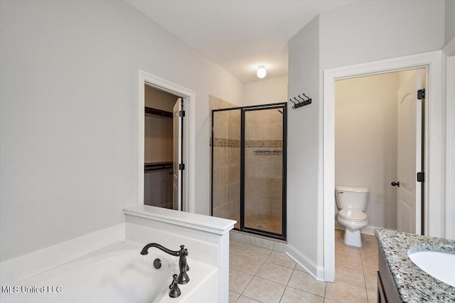 full bathroom with tile patterned floors, vanity, separate shower and tub, and toilet