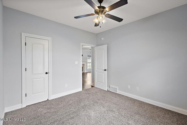 unfurnished bedroom featuring carpet flooring and ceiling fan