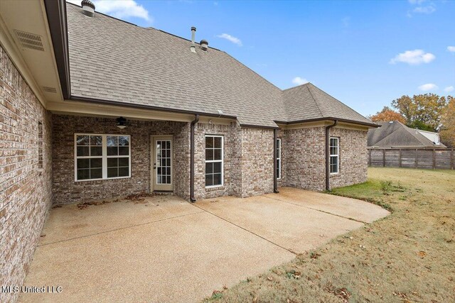 back of house with a patio