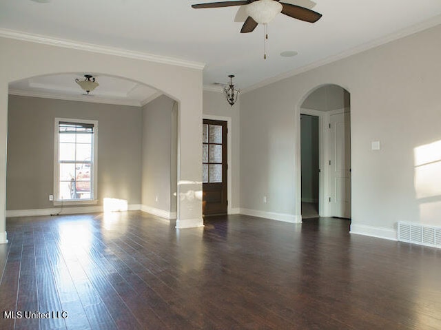 empty room with crown molding, ceiling fan, and dark wood-type flooring