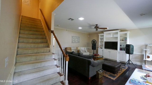 living room featuring dark wood-type flooring, ceiling fan, and crown molding