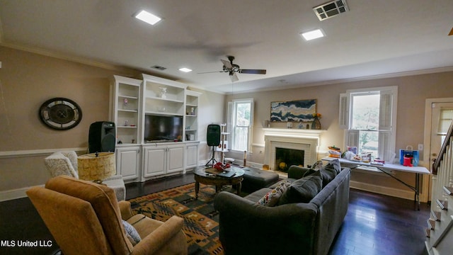 living room with ornamental molding, a brick fireplace, dark hardwood / wood-style floors, and ceiling fan