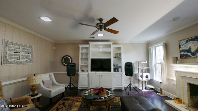 living room with ceiling fan, ornamental molding, a brick fireplace, and dark hardwood / wood-style floors