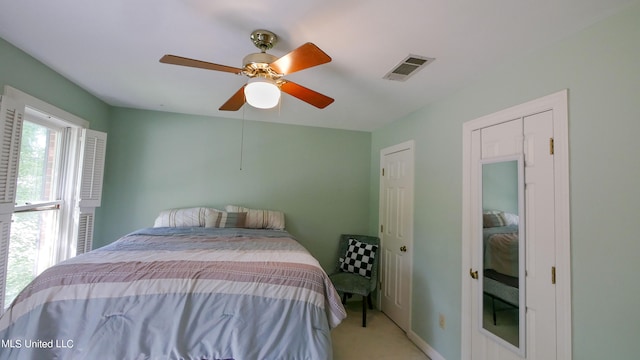 bedroom featuring ceiling fan and light carpet