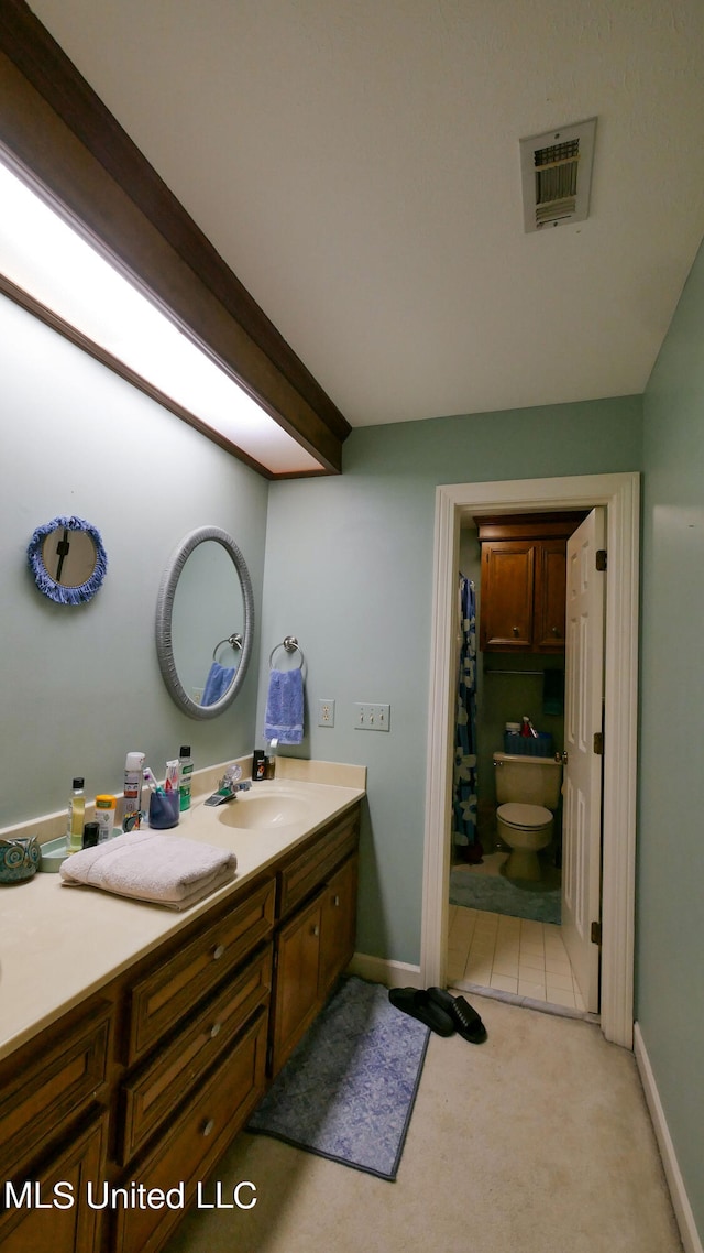 bathroom with vanity and toilet