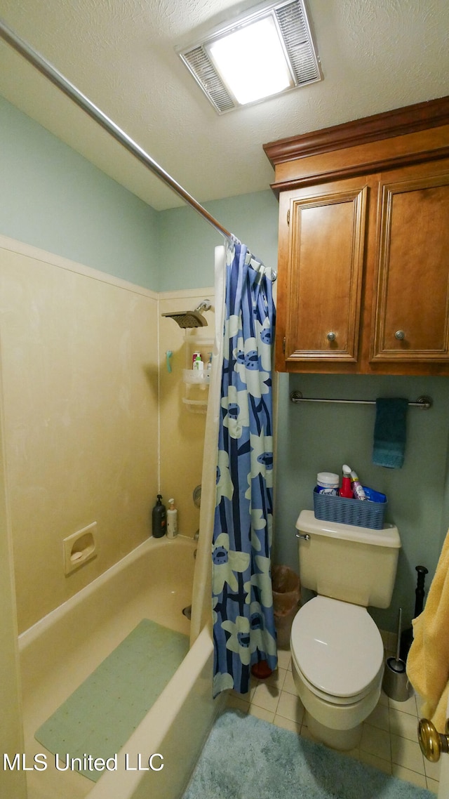 bathroom with tile patterned floors, shower / bath combo, a textured ceiling, and toilet