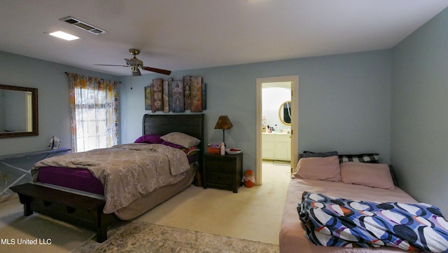 bedroom featuring ensuite bath, carpet, and ceiling fan