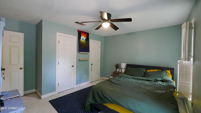 bedroom featuring light carpet and ceiling fan