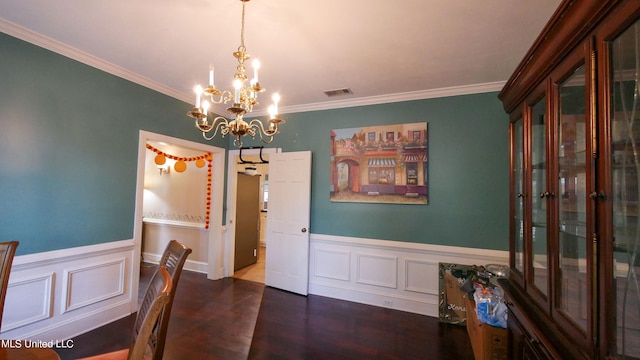 dining area featuring ornamental molding and a chandelier