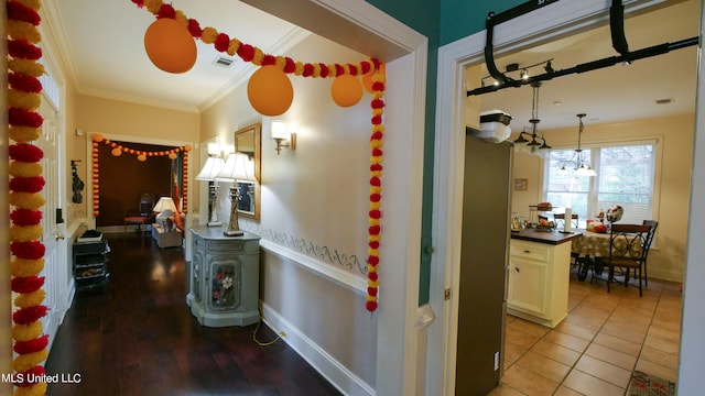 hallway featuring crown molding and light hardwood / wood-style floors