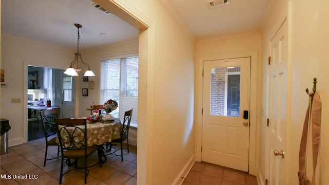 dining area with crown molding and light tile patterned flooring