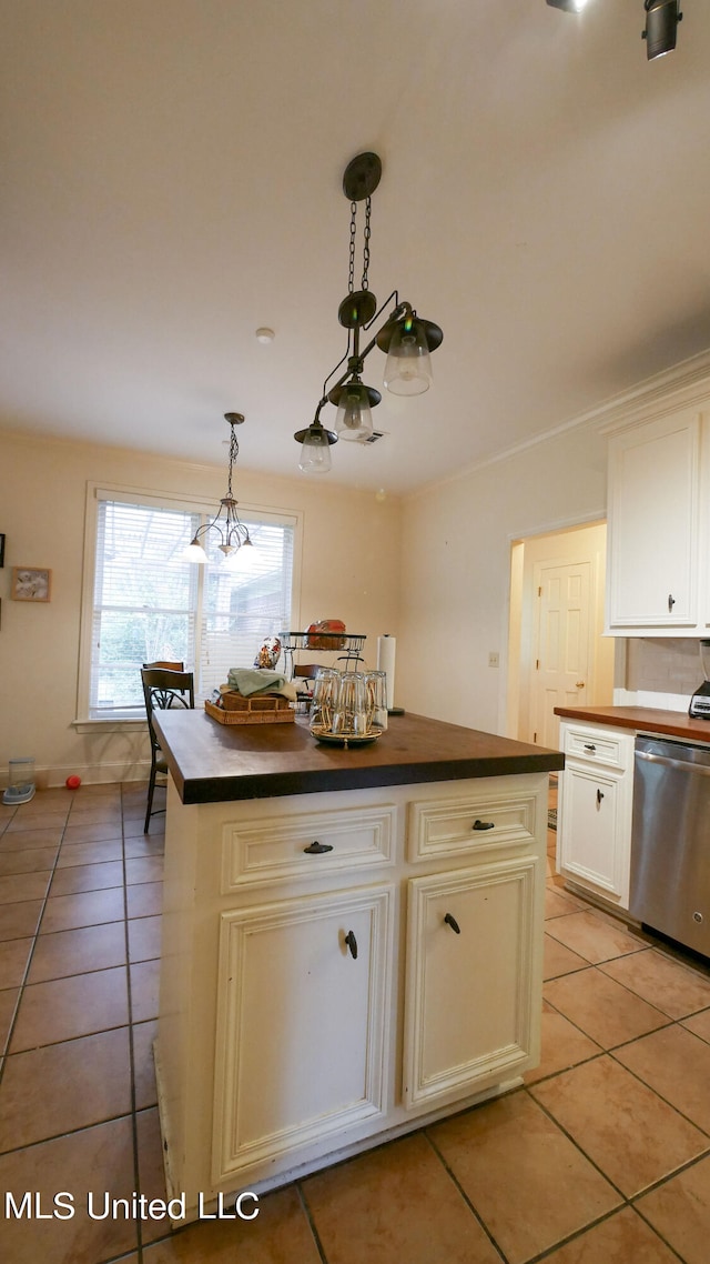 kitchen with a center island, stainless steel dishwasher, hanging light fixtures, and light tile patterned floors