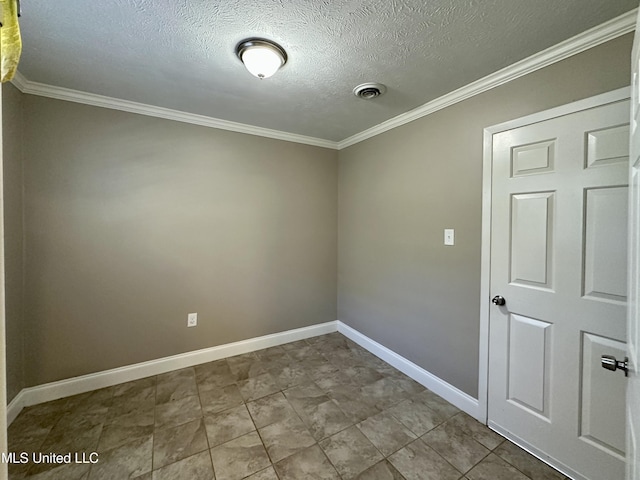 spare room with ornamental molding and a textured ceiling