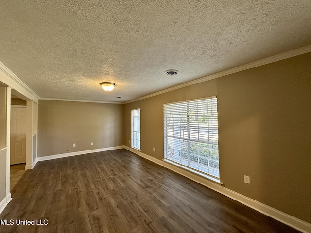 empty room featuring a textured ceiling, dark hardwood / wood-style floors, and ornamental molding