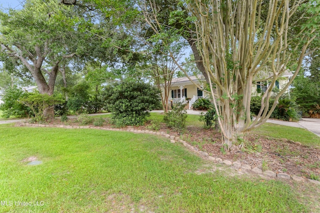 6658 Ahekolo Cir, Diamondhead, MS 39525 - view of grassy yard featuring a porch