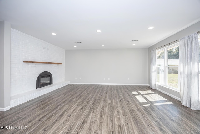 unfurnished living room with dark wood-type flooring and a fireplace