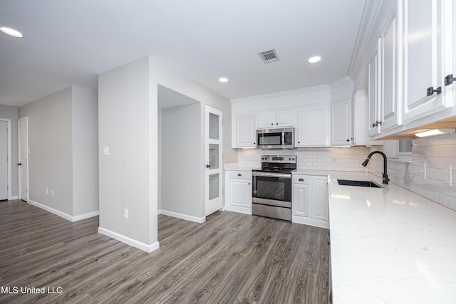 kitchen featuring white cabinets, stainless steel appliances, hardwood / wood-style floors, and sink