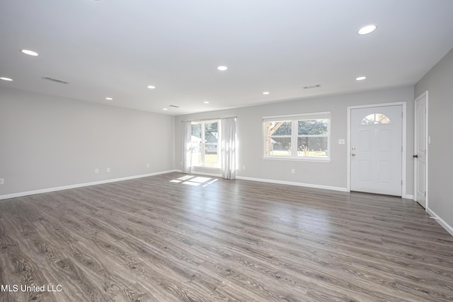 unfurnished living room featuring dark wood-type flooring