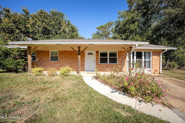 ranch-style house with a front lawn and a carport