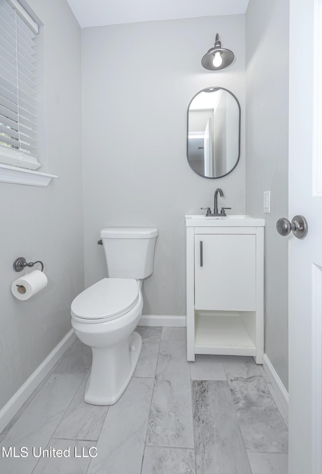 bathroom featuring toilet and vanity