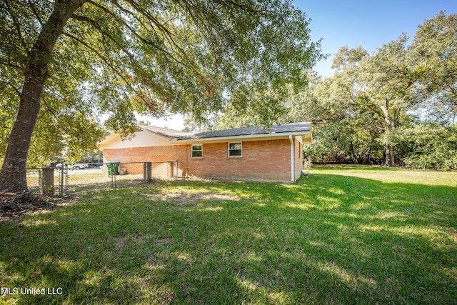 rear view of property featuring a yard