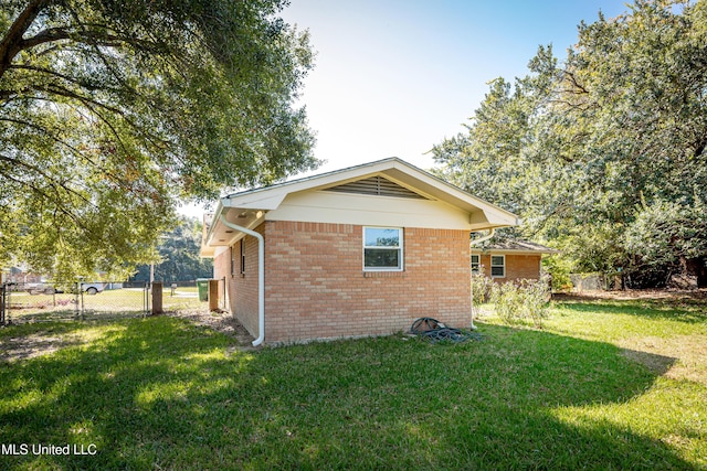 view of property exterior with a lawn