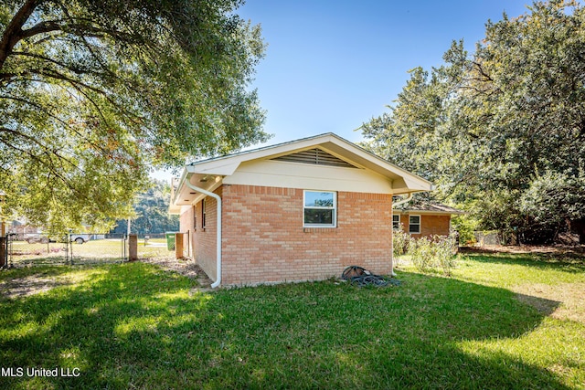 view of side of home featuring a yard