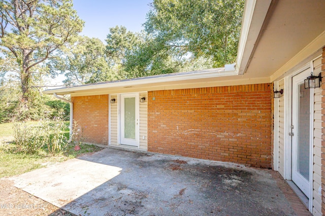 property entrance featuring a patio area