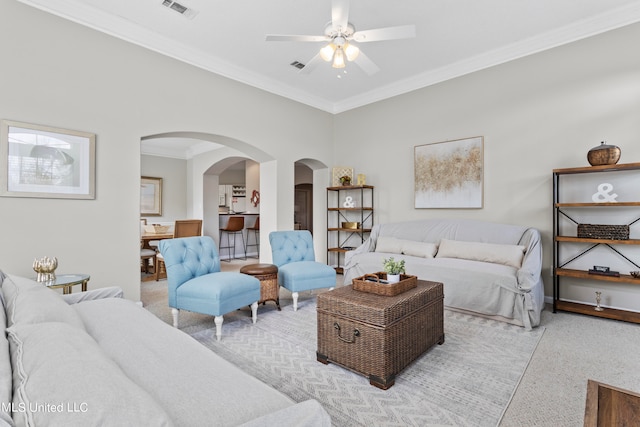 living room with ornamental molding and ceiling fan