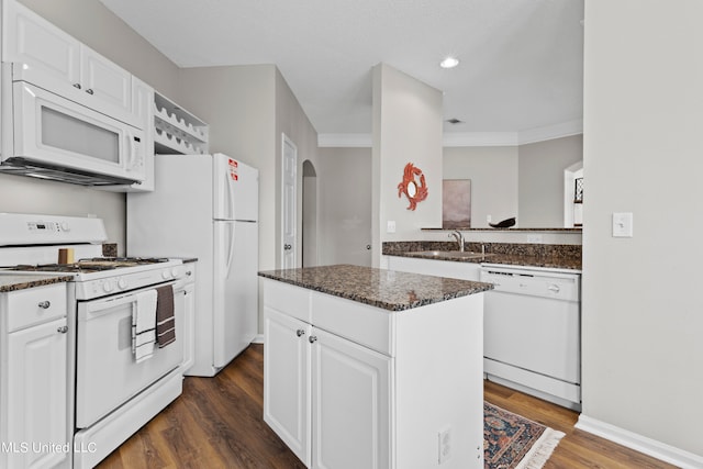 kitchen with a center island, white cabinetry, white appliances, and dark hardwood / wood-style flooring