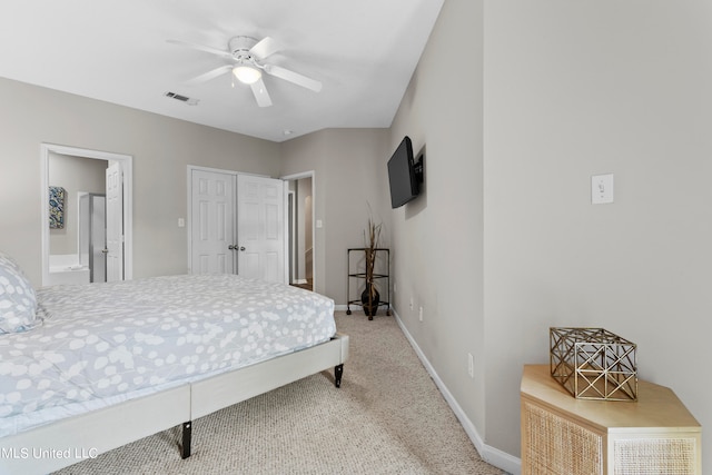 bedroom featuring ensuite bath, carpet flooring, and ceiling fan