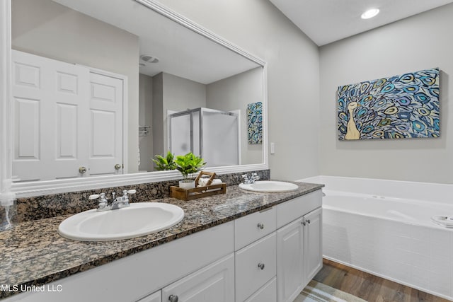 bathroom with vanity, hardwood / wood-style floors, and shower with separate bathtub